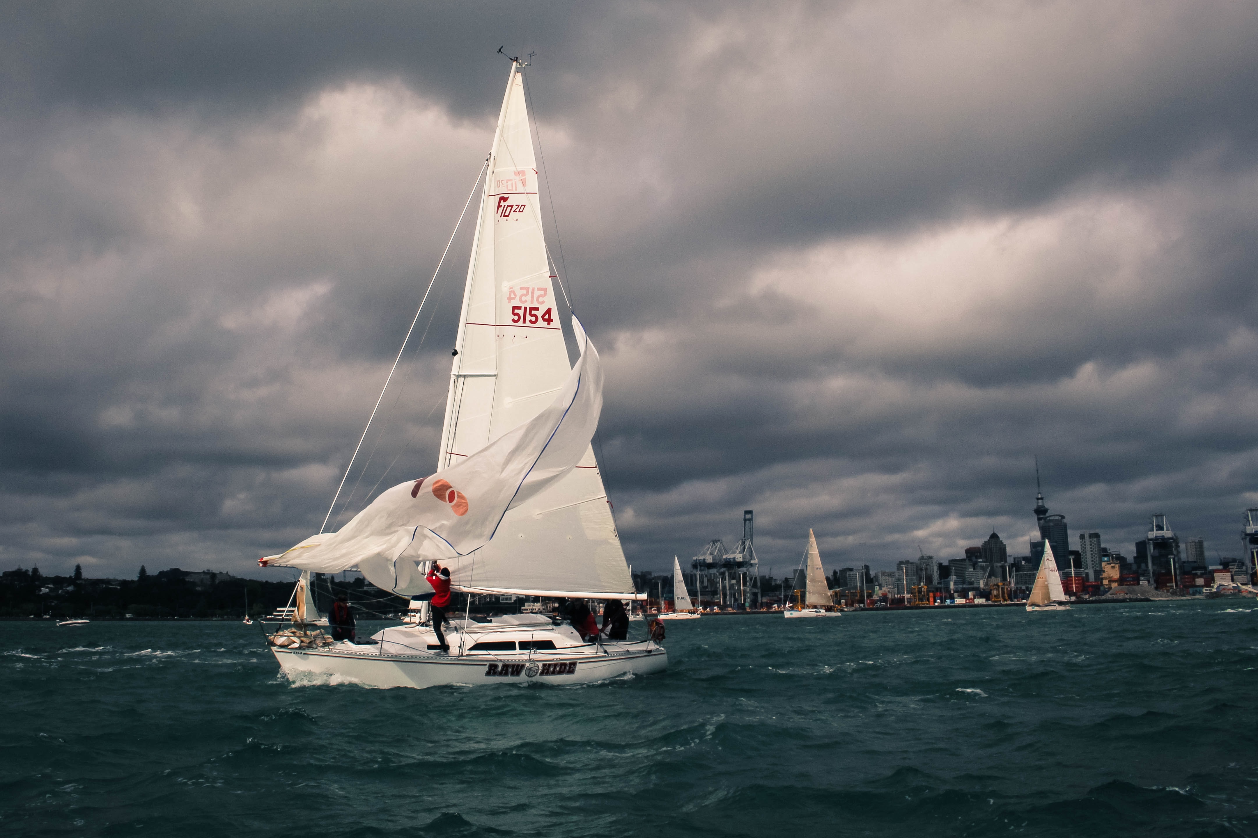 An image of a sailboat on the water on a stormy day.